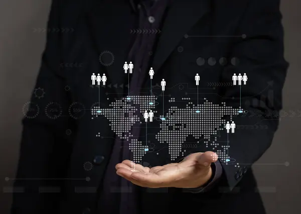 Concepts about personnel management in organizations. Businessman using mobile phone showing virtual screen of world map and employee icons. HRM recruitment employee for company.
