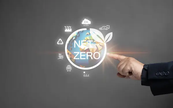 net zero emissions and Carbon neutrality concept. sustainable and clean tech. global warming. Environmental protection, climate eco energy. Man point the net zero globe icon on virtual screen.