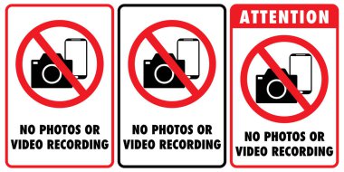 Fotoğraf ve video kaydının yasaklandığını gösteren üstü çizili fotoğraf makinesi ve telefon işaretleri. İşaretlerden birinde 