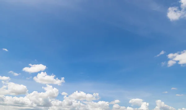 Panoramic view of clear blue sky and clouds, Blue sky background with tiny clouds. White fluffy clouds in the blue sky. Captivating stock photo featuring the mesmerizing beauty of the sky and clouds.
