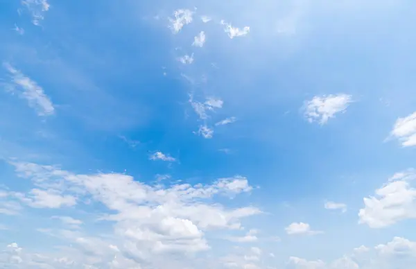 Panoramic view of clear blue sky and clouds, Blue sky background with tiny clouds. White fluffy clouds in the blue sky. Captivating stock photo featuring the mesmerizing beauty of the sky and clouds.