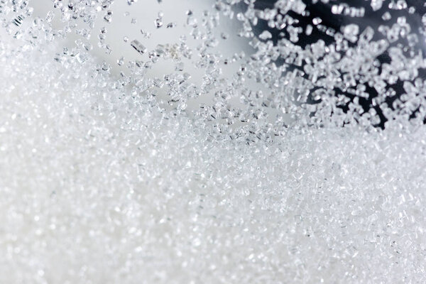Close up of crystal sugar in Glass bottles on white background.