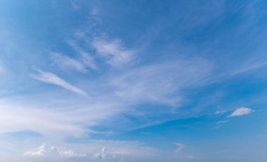 Panoramic view of clear blue sky and clouds, Blue sky background with tiny clouds. White fluffy clouds in the blue sky. Captivating stock photo featuring the mesmerizing beauty of the sky and clouds. clipart