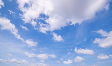 Açık mavi gökyüzü ve bulutların panoramik görüntüsü, küçük bulutlu mavi gökyüzü arkaplanı. Mavi gökyüzünde beyaz kabarık bulutlar. Gökyüzünün ve bulutların büyüleyici güzelliğini gösteren büyüleyici stok fotoğrafı..