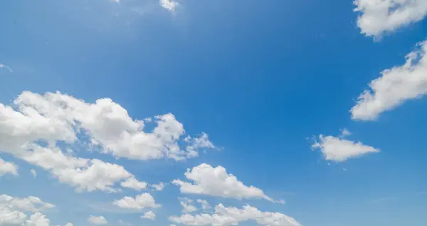stock image clear blue sky background,clouds with background, Blue sky background with tiny clouds. White fluffy clouds in the blue sky. Captivating stock photo featuring the mesmerizing beauty of the sky and clouds.