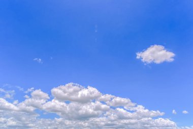Açık mavi arkaplan, arka planda bulutlar, küçük bulutlu mavi gökyüzü arkaplanı. Mavi gökyüzünde beyaz kabarık bulutlar. 