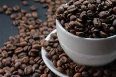 kahve beyaz Kupası ve kahve çekirdekleri arka plan vardır.