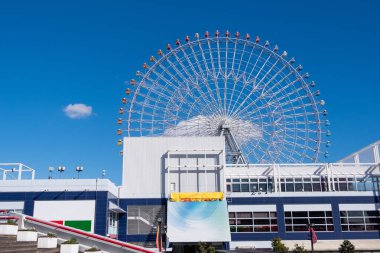 Osaka Akvaryumu Kaiyukan Osaka, Japonya 'daki eğlence parkında mavi gökyüzünün arka planında dönme dolap..