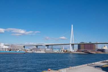 Osaka Akvaryumu Kaiyukan Osaka, Japonya 'daki eğlence parkında mavi gökyüzünün arka planında dönme dolap..