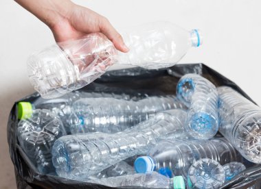 Siyah çöp torbalarındaki plastik şişeler geri dönüşüm için alınmayı bekliyor..