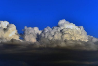 huge clouds in a blue sky clipart