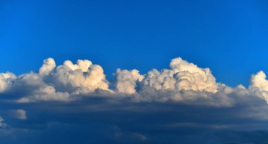 huge clouds in a blue sky clipart