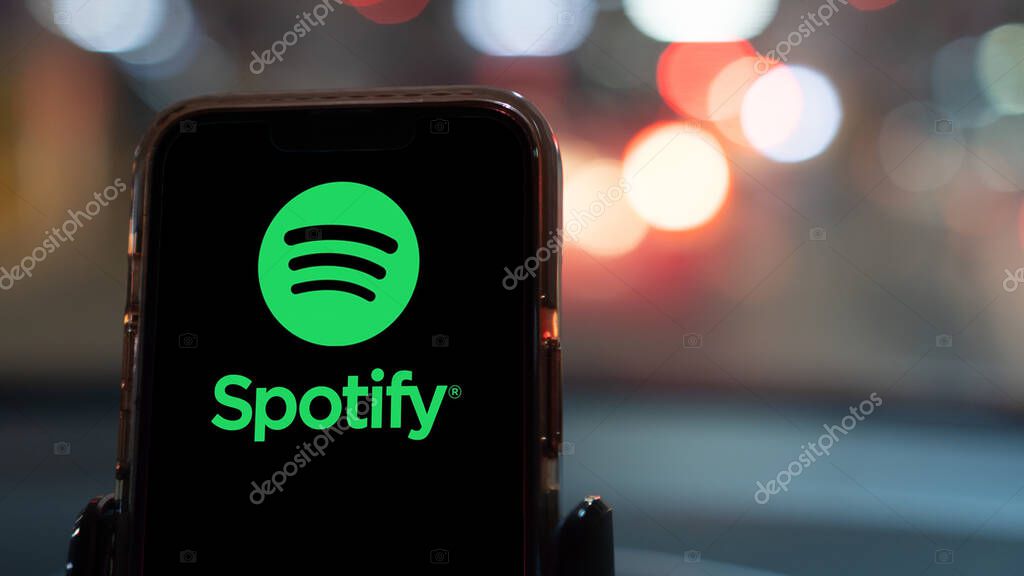 Istanbul, Turkey - February 20, 2024: Spotify app on a smartphone in a car. Spotify is a music streaming service for smartphones and computers.
