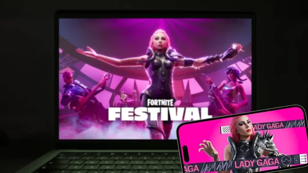İstanbul, Türkiye - 22 Şubat 2024: Lady Gaga Fortnite Festivali akıllı telefon ekranı ve arkadaki bilgisayarda oyun ekranı