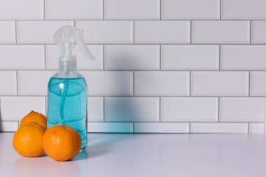 Glass spray bottle in the kitchen. Cleaning concept