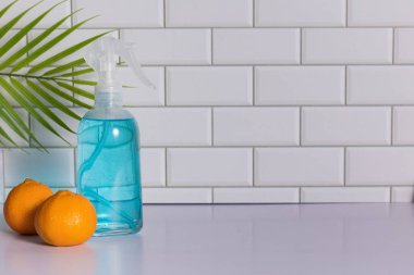 Glass spray bottle in the kitchen. Cleaning concept