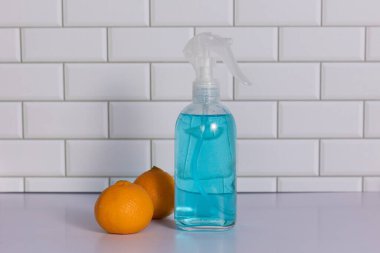 Glass spray bottle in the kitchen. Cleaning concept
