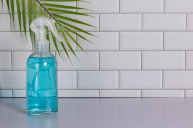 Glass spray bottle in the kitchen. Cleaning concept