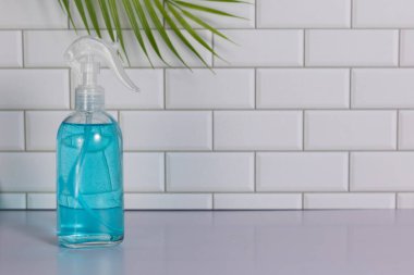 Glass spray bottle in the kitchen. Cleaning concept