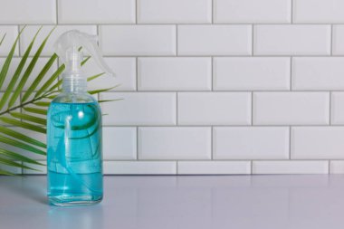 Glass spray bottle in the kitchen. Cleaning concept