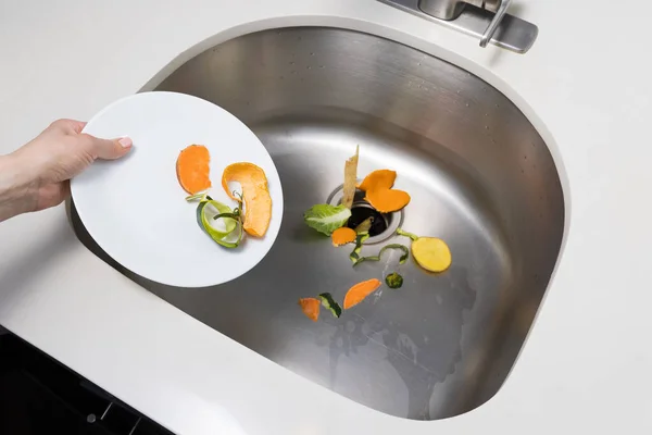 Woman Trowing Away Food Scraps Kitchen Sink Stock Photo