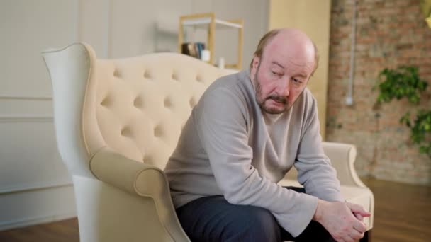 Pensive Introspective Senior Man Sits Plush Velvet Sofa Grand Stately — Video