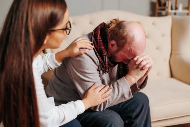 an american bald old man a psychologist at a clinic. Retired male consultation By specialist psychiatrist examination, support, talk, psychiatrist and man feeling, people expression, male anxious,