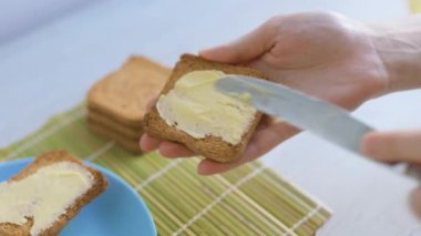 A product shot of butter being spread on a piece of bread, emphasizing the importance of healthy eating habits.