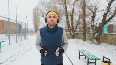 A candid shot of a man, running with headphones on and a smartphone in hand, embracing technology as part of his healthy lifestyle. showcasing the mental and physical benefits of a healthy lifestyle.
