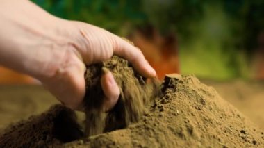 Zengin topraklara parmak uçlarına özenli bir şekilde yerleştirilmiş insan eli.