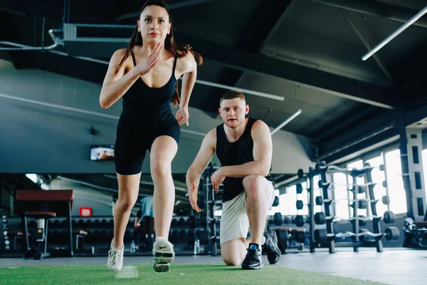 Portre, erkek kişisel antrenörle motivasyon sahibi bir kadın arasındaki gerçek etkileşimi, spor yapma konusundaki ortak tutkularını ve sağlıklı bir yaşam tarzına olan bağlılıklarını gösteriyor..