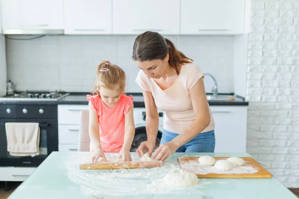 stock image Embracing domestic joy, a mother and her daughter knead dough side by side, celebrating family time in the kitchen. Creating Memories Domestic Bliss with Mother and Daughter in the Kitchen