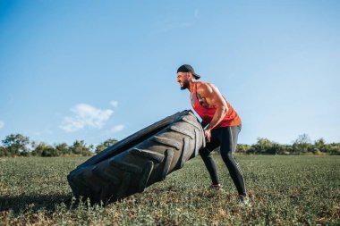 Bu beyaz erkek, sert bir Cross Fit egzersizinin tam ortasında, kaslı fiziğini ve hünerini gösteriyor..