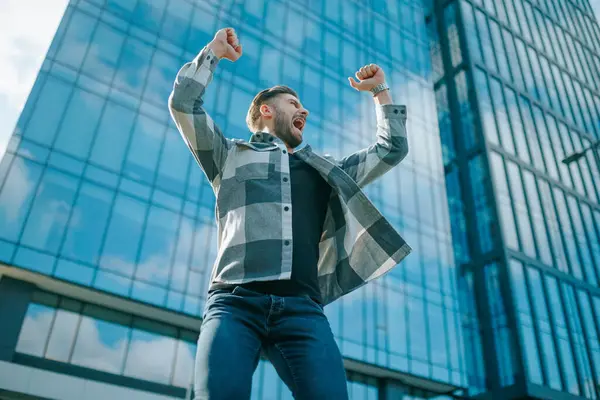 Şehir hayatının ortasında, sakallı beyaz bir adam başarısını kutlamak için mutlulukla ışıldıyor. Onun gerçek neşesi başarısının bir kanıtıdır..