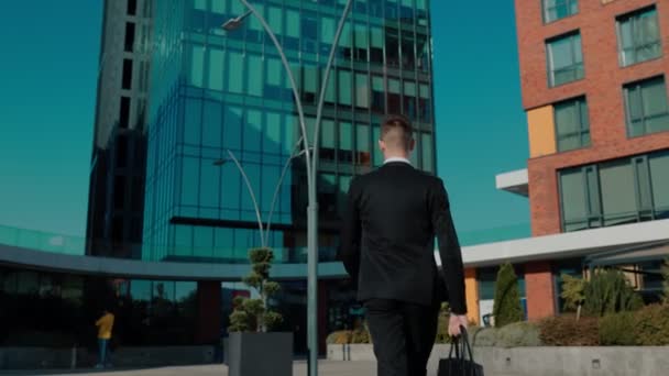Dynamic Tracking Shot Caucasian Businessman Striding Confidently Urban Business District — Stock Video