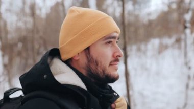 Aşırı kış sporunun coşkulu bir gösterisine katılan kararlı, beyaz sakallı bir adam, karlı yollarda korkusuzca yürüyüş yapar.,