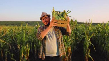 . Hava güzel, güneşli iş günü. Mutlu genç adam hasadını kontrol ediyor..