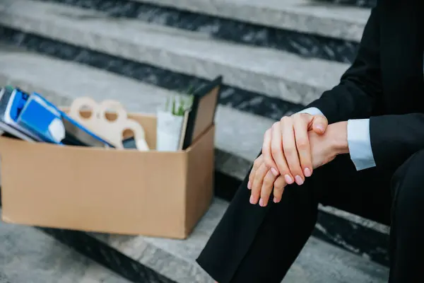 stock image The devastating impact of the recession on people's lives - a pair of hands holding a carton box. Packing Up The Emotional Toll of Unemployment in a Carton Box