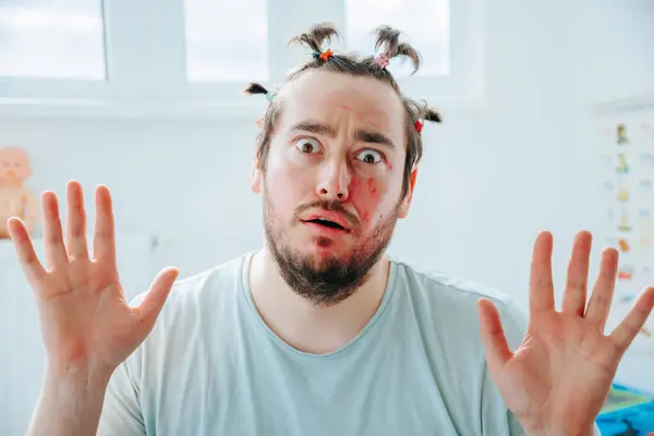 stock image A caucasian man with makeup is gazing at the camera with a bizarre expression. Surprised Father's Make Up Experiment