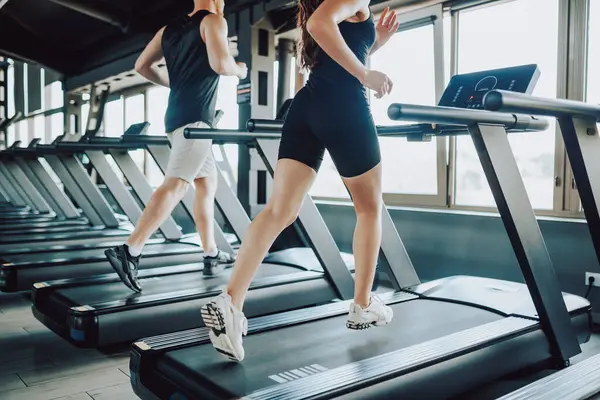 stock image Caucasian Man and Hispanic Woman treadmill Striving for Physical Excellence. Active Hispanic and American Duo Inspiring Others in Fitness Journey