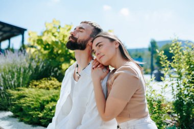 The love and affection shared between a girlfriend and boyfriend are beautifully showcased in this heartwarming photo, capturing their happiness and togetherness during their outdoor escapade. clipart