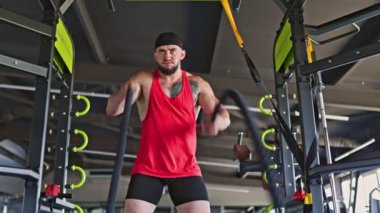 Spor salonu kaslı, genç ve kararlı bir adam olarak enerjiyle dolu. Kendini yoğun bir halat antrenmanına adadı. Onun atletik ruhu parlıyor