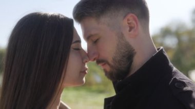 Barışçıl bir açık hava ortamında, bir çift, sonbaharın sıcaklığını ve ilişkilerindeki aşkı kucaklarken yüzleri kapalı bir anı paylaşır..