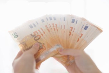 Kişisel ve iş finansmanı kapsamında avro banknotları tutan, refah, para tasarrufu ve mali işlemleri gösteren bir kişi.