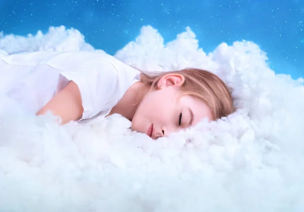 little girl sleeps sweetly in the clouds