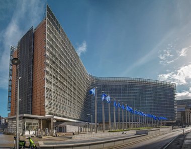 Brüksel, Belçika - 19 Eylül 2022: Avrupa Komisyonu binasına karşı mavi bayraklı büyük bir panorama. Perspektif görünümü