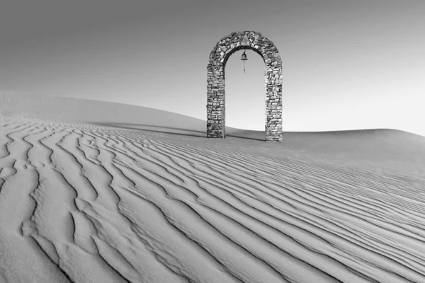 Surreal landscape with lonely ancient stone arch with bell in desert. Abstract minimalist black and white scene. Sand dunes, gradient sky