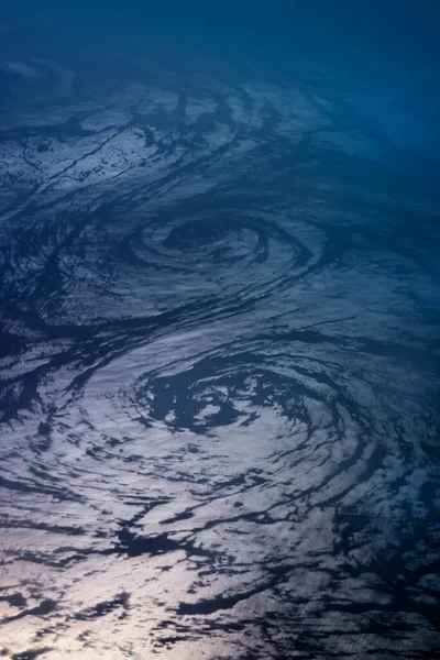 Aerial view on two huge spiral flows in the ocean creating an enormous whirlpool in the form of eight. Beauty of nature