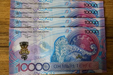 10,000 tenge 'lik parçalar masanın üzerinde duruyor.