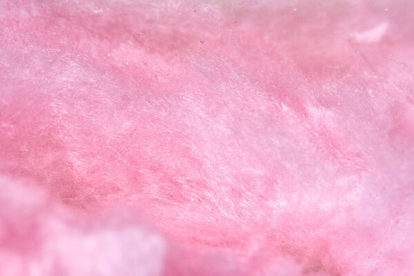 Macro photo of sweet pink cotton candy, backdrop.